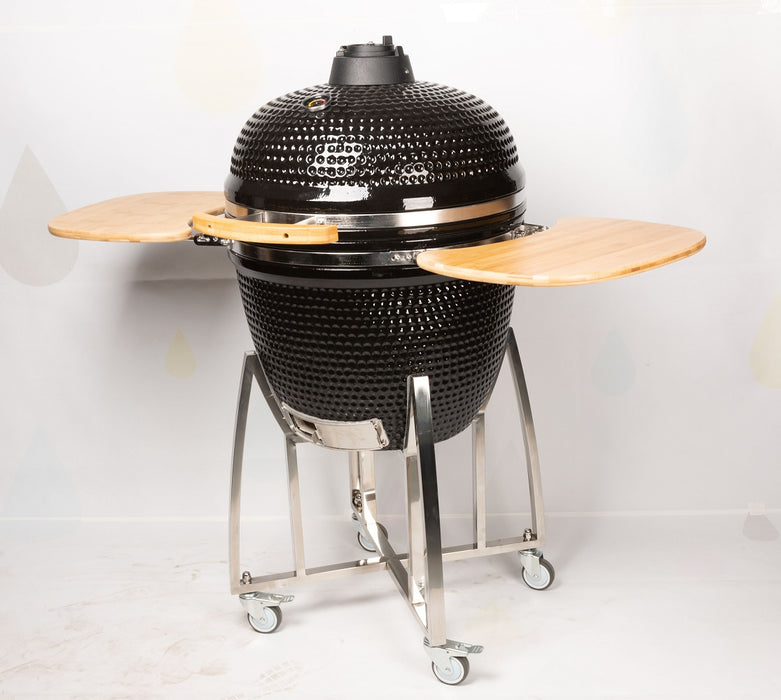 Black ceramic kamado-style BBQ with dome lid and steel frame on wheels view 2
